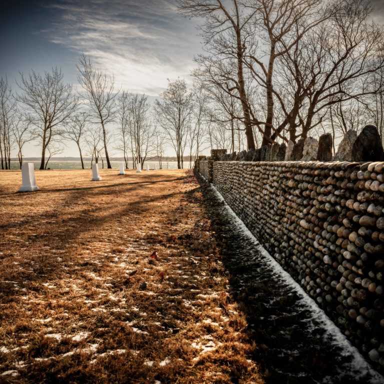 A view from hart island along a stone wall leading out to the long island sound