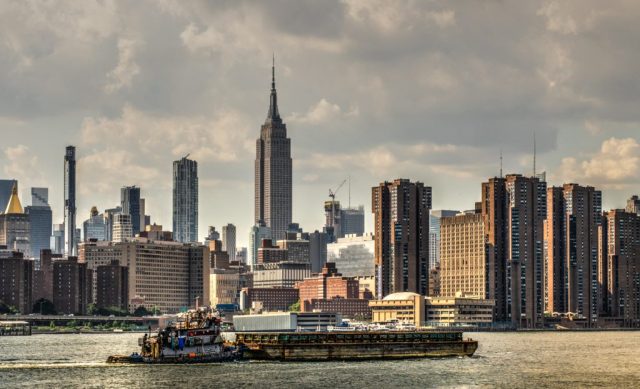 Tugboat, Barge, and NYC Skyline - Photographer: Bonnie Forman-Franco Tugboat, Barge, and NYC Skyline - Photographer: Bonnie Forman-Franco