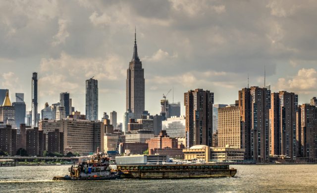 Tugboat, Barge, and NYC Skyline - Photographer: Bonnie Forman-Franco